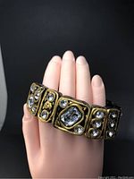 Front view of the stretch bracelet showing large faceted crystals and rhinestone decorations on wooden base segments.