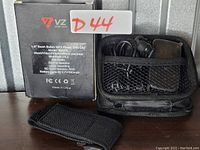 Photo of MP3 player box with model and features listed plus accessories including carrying case, earphones, and strap.