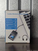 Front of packaging showing product image and key features: easy to operate, HiFi stereo sound, long range up to 10 meters, visual display.