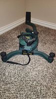 Full front and top view of Caldwell Lead Sled showing green frame, front gun rest with black plastic cradle, and adjustable knobs.