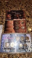Photo showing three plastic coin holders: Mercury dime mint mark collection with Philadelphia, Denver, San Francisco marks; three centuries of nickels; and mint mark category coins.