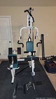 Full view of the Pacific Fitness Zuma home gym showing the entire machine with padded seats, backrest, and arm bars