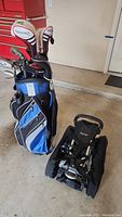 Assembled Datrek golf bag standing next to folded BagBoy Turbo push cart