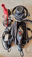 Photo of Roto Zipsaw, Milwaukee Grinder, Black & Decker Planer, and Craftsman Buffer Polisher grouped on floor showing all tools and cords