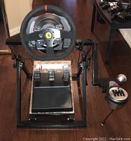 Full setup: wheel mounted on stand with pedal assembly and separate shifter