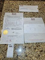 Documents and paperwork including Shane Co envelope, certified appraisal, invoice and MaxSold tag on countertop