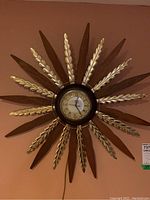 Front view of clock showing full starburst design and dial