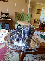 Full view of the silver-plated tea set on the ornate tray, showing two teapots, creamer and sugar bowl, detailed silver tray with decorative border