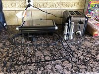 Overall view of the Breville panini press, Cuisinart toaster, plate rack, and salt & pepper mills on a countertop.