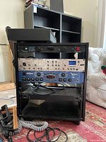 Front view of guitar effects rack with equipment installed including Furman, Behringer, Alesis, and Vox units.