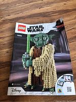 Instruction manual for Lego Star Wars set 75255 Yoda showing front cover with Yoda holding a green lightsaber.