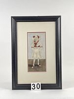 Full view of framed watercolour painting showing young girl in white dress with red detail, black frame, and numbered label 30 in front.