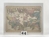 Full view of the antique hand-coloured map mounted on white board with protective shrink-wrap, showing the complete map with surrounding white border.
