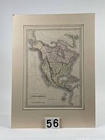 Full front view of the antique hand-coloured North America map mounted on white-board with a number 56 marker in front.