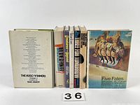 Front view of spines and covers of 7 science fiction books including The Hugo Winners, Five Fates.