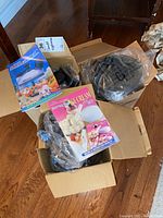 Box containing Rocket Chef Supreme Ice Cream Set with instructions and multiple parts including ice cream maker components and storage containers.