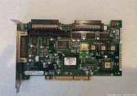 Photo of Adaptec FastTrak SE controller card showing front side with chipsets and connectors.