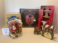 Full lot photo showing Dept 56 Dedlock Arms ornament, Nutcracker book, and stocking hangers.