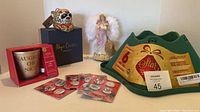 Photo showing all items included: tree stand, angel figurine, candle holder, Rudolph buttons, and Magdalena ornament dog figure.