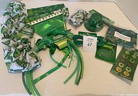 Full lot spread showing all St Patrick's Day themed accessories including scarf, bowtie, headbands, eyeglasses, buttons, bracelet, and small hat.
