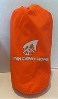 Orange compression storage bag for inflatable sleeping pad with RAIN DEW+HOME logo