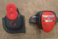Two black and red scrapbooking border punches. Left punch has red lever and unclear marking on base. Right punch shows lace floral design in red on punch lever.