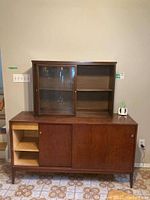 Full front view of the cabinet set showing both upper and lower parts, sliding doors, and shelving compartments.