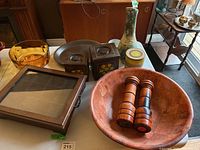 Full view of vintage pottery and wood decor items on table including bowls, boxes, framed item, vases, and shakers