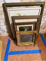 Four stacked framed artworks showing variety of frame types and sizes