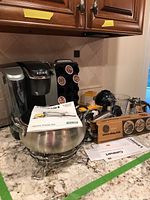 Wide view of Keurig coffee maker, Cuisinart fondue pot, GE slicer box, and blender placed on kitchen counter