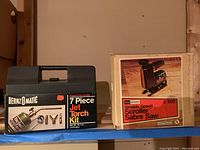 Bernzomatic 7 Piece Jet Torch Kit plastic case next to Craftsman Sabre Saw box on shelf