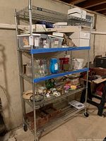 Full assembled shelving unit loaded with miscellaneous items