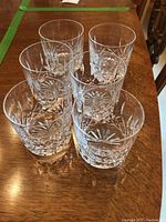 Top view of six glasses arranged in a circle showing starburst base cut