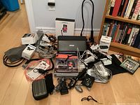 Group shot of all items: scanner, books, boxes, stand, cables and adapters