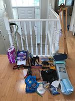 Photo taken showing full assortment of health aids and incontinence products arranged on hardwood floor near white railing.