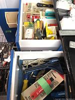 Wide view of tool drawers showing various hand tools including locking pliers, paint scrapers, and a new SideSculper II in packaging.