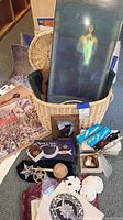 Photo shows large framed Maxfield Parrish poster, several mystical posters, wicker basket, assorted small decorative items including pentacle discs and a Moon Crest knife box.