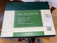 Top view of original box with green and beige color showing Brookstone golf putting set details