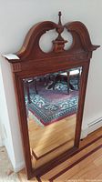 Full view of Pulaski Furniture mirror showing wood frame, carved details, and mirror glass.