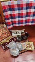 Overall lot arrangement on floor including tray, napkin rings, place card holders, tea set, vases, and wooden serving dish