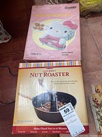 Original box of the Hello Kitty waffle maker showing the product image and branding.