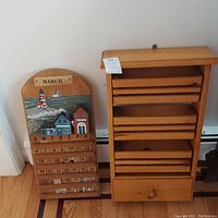 Image showing both wooden wall calendar and wooden wall organizer side by side, against a wall and floor background.