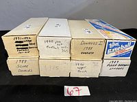 Six cardboard boxes labeled with different card sets and years, stacked horizontally showing titles such as '1991-1992 Upper Deck Football', '1990 Pro Set football 227-325', 'Donruss 1988 Complete', '1988 Score Doubles', '1985', '1990 Upper Deck', and '1989 Fleer Baseball Stickers'.