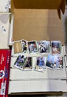 Photo of baseball and football cards laid out for viewing with visible player cards