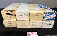 Seven boxes of collectible sports cards, with handwritten labels indicating years and brands including Upper Deck, Donruss, Score, Fleer and Topps.