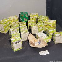 20 Enesco Country Cousins boxed figurines arranged on black surface, showing most boxes in original packaging with colorful woodland cartoon design.