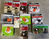 Overview of all boxed LED and outdoor lighting items in the lot including pathway lights, flood lights, and security lights.