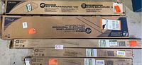 Multiple boxes of Commercial Electric 4 ft Integrated LED Wraparound lights stacked, showing brand and length details.