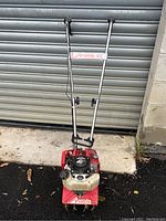 Full view of the Mantis edger showing handlebars and engine mounted on red body with a white translucent fuel tank.