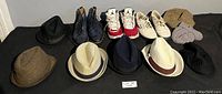 Full overview of all shoes and hats included in the lot, showing arrangement and variety